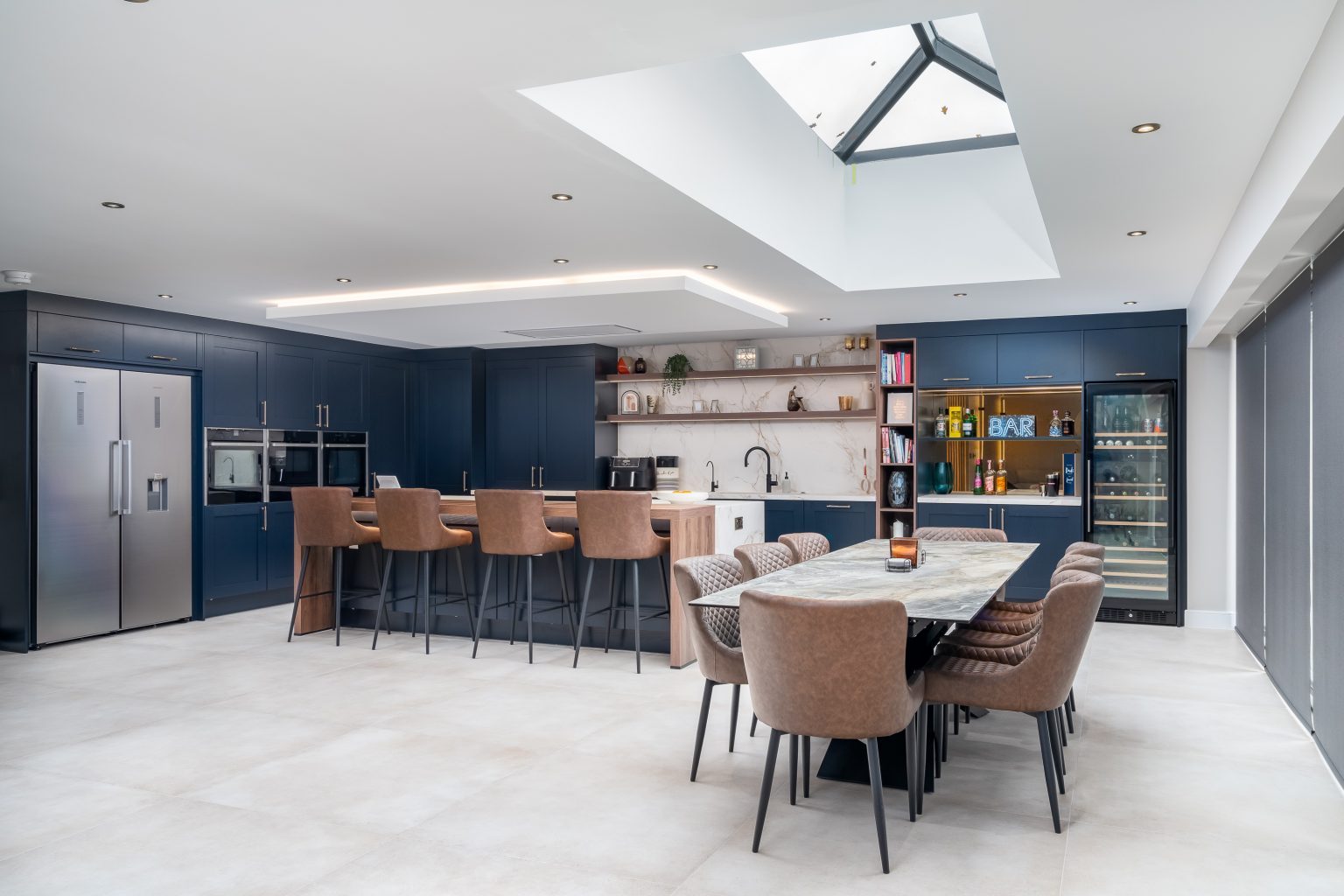 Light-filled kitchen with blue cabinetry and a stone island